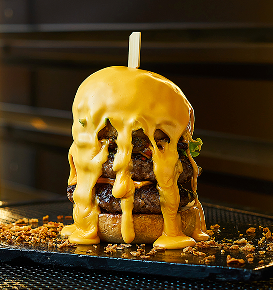 Burger dripping with cheese